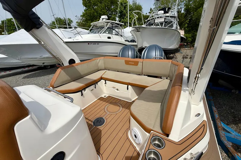 Slide: The Image of 2024 Zodiac Medline 9 boat interior with cushioned seating and dual engines. - 23