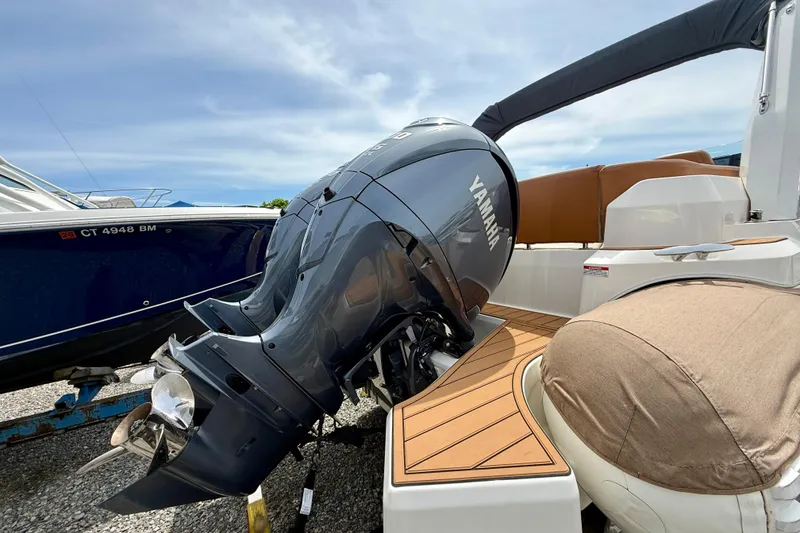 Slide: The Image of 2024 Zodiac Medline 9 boat with Yamaha outboard motor, docked on gravel. - 26