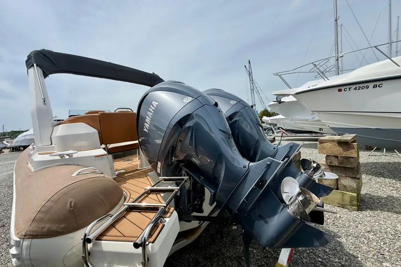 Slide: The Image of 2024 Zodiac Medline 9 boat with dual Yamaha outboard engines, docked on gravel. - 27