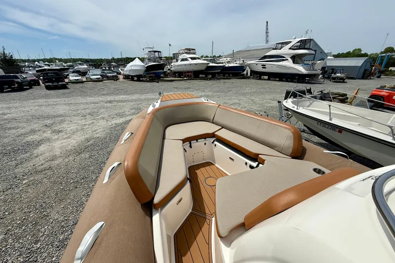 Slide: The Image of 2024 Zodiac Medline 9 boat with spacious seating, docked in a marina with other vessels. - 4