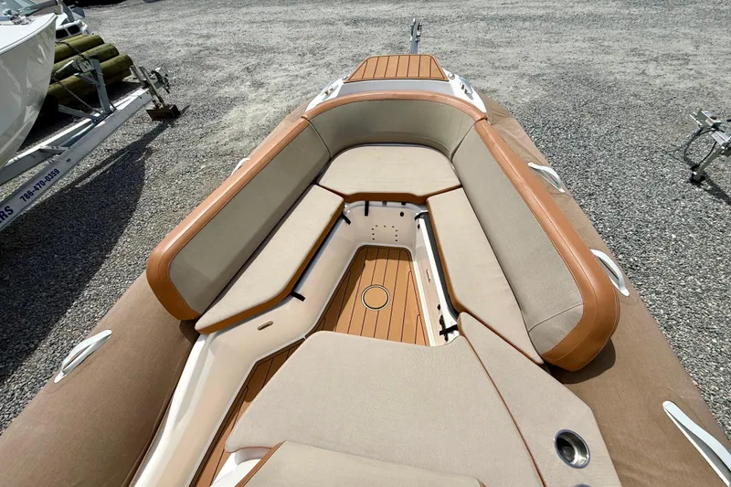 Slide: The Image of 2024 Zodiac Medline 9 boat interior with beige and brown seating, wooden deck. - 6