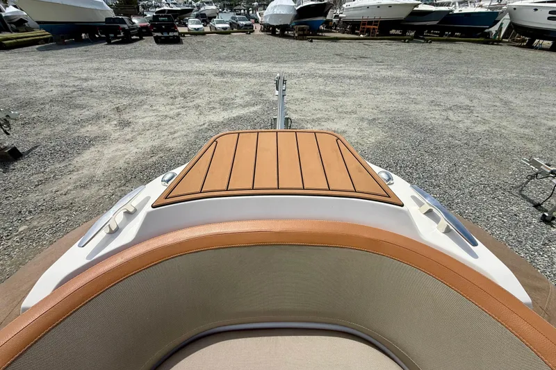 Slide: The Image of 2024 Zodiac Medline 9 boat bow view at a marina with parked boats. - 7