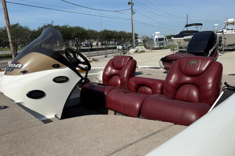 Slide: The Image of 2001 Triton Tr-186 boat with red leather seats and steering console. - 11