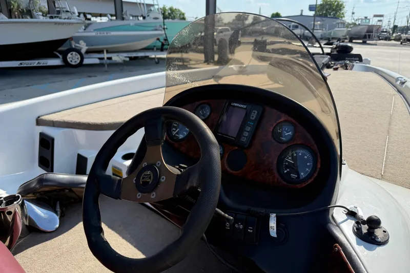 Slide: The Image of 2001 Triton Tr-186 boat dashboard with steering wheel and instrument panel. - 13