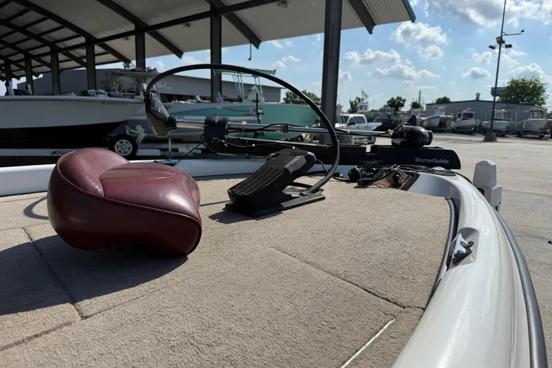 Slide: The Image of 2001 Triton Tr-186 boat deck with maroon seat and MotorGuide trolling motor. - 14