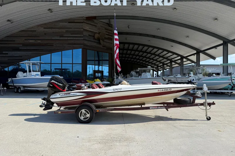 Slide: The Image of 2001 Triton Tr-186 boat on trailer at The Boat Yard, featuring Mercury engine. - 2