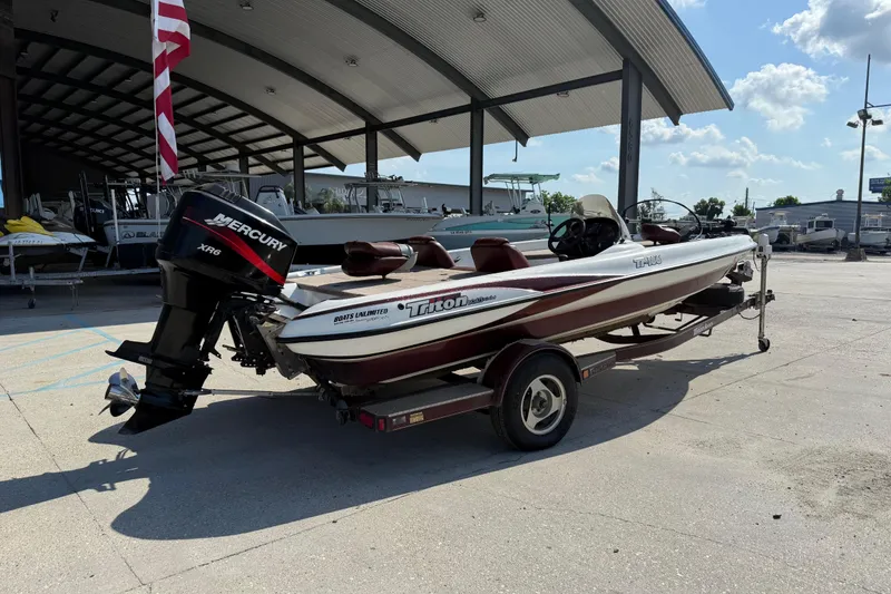 Slide: The Image of 2001 Triton Tr-186 boat with Mercury XR6 engine on trailer, parked outdoors. - 3