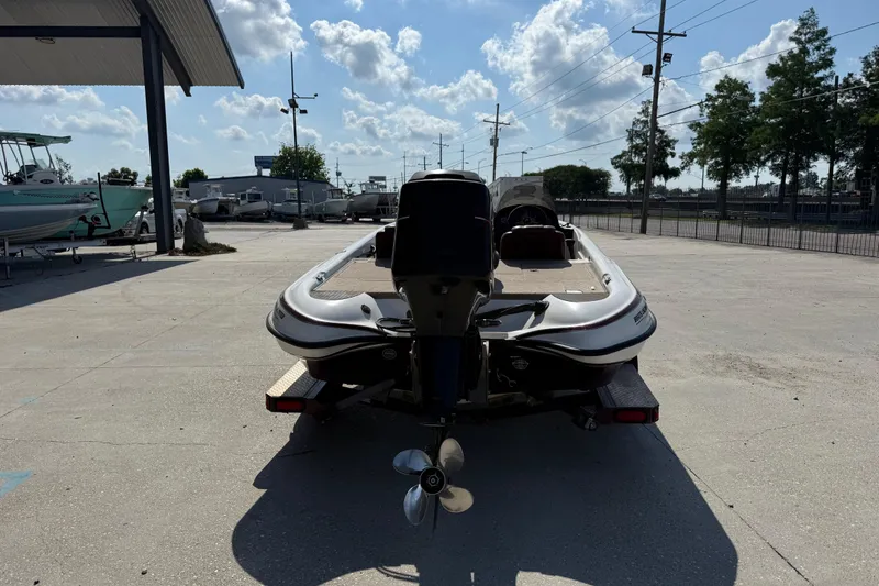 Slide: The Image of 2001 Triton Tr-186 boat on trailer in outdoor lot under blue sky. - 4