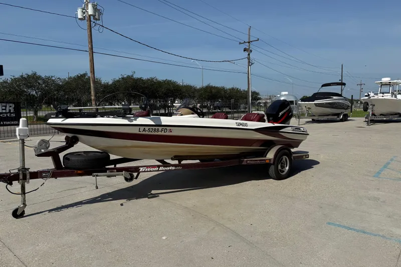 Slide: The Image of 2001 Triton Tr-186 boat on trailer in parking lot, sunny day. - 7