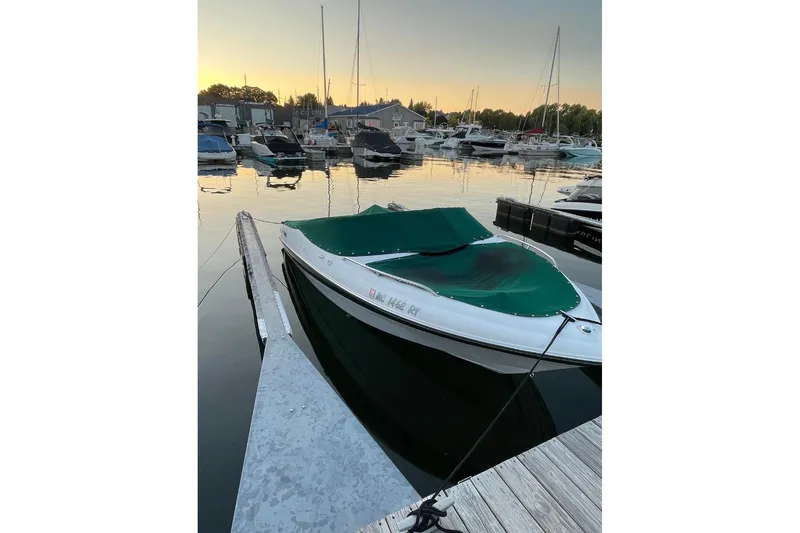 The Image of 1999 Four Winns 180 Horizon boat docked at marina during sunset. - 0