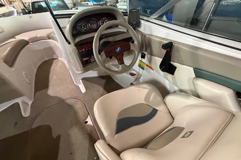 Slide: The Image of 1999 Four Winns 180 Horizon boat interior with steering wheel and dashboard controls. - 11
