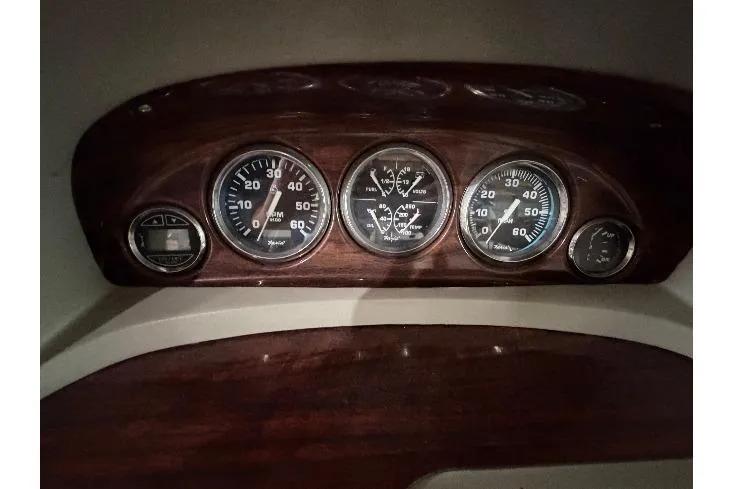 Slide: The Image of Dashboard of a 1999 Four Winns 180 Horizon boat with gauges and controls. - 12