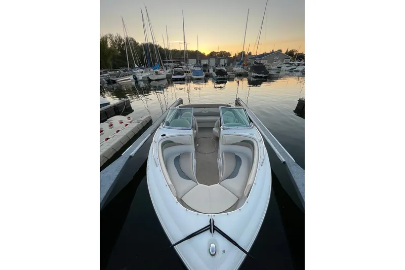 Slide: The Image of 1999 Four Winns 180 Horizon boat docked at marina during sunset. - 2