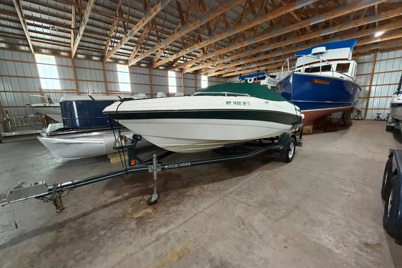 Slide: The Image of 1999 Four Winns 180 Horizon boat stored indoors on a trailer. - 4
