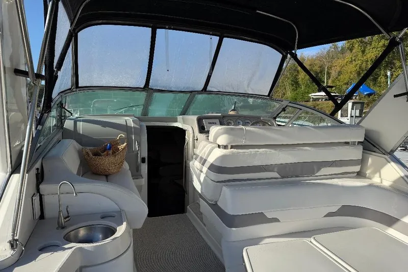 Slide: The Image of 2000 Formula 31 Performance Cruiser interior with seating, sink, and basket under canopy. - 2