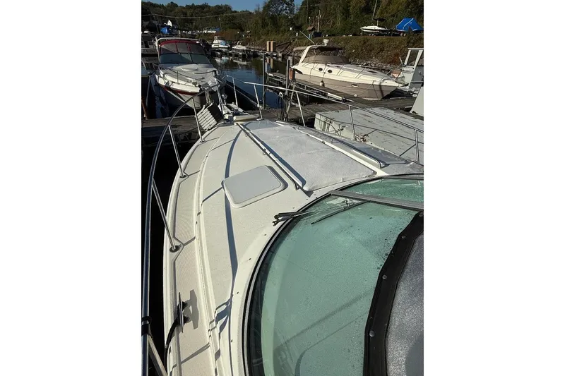 Slide: The Image of 2000 Formula 31 Performance Cruiser docked at marina, surrounded by other boats. - 3