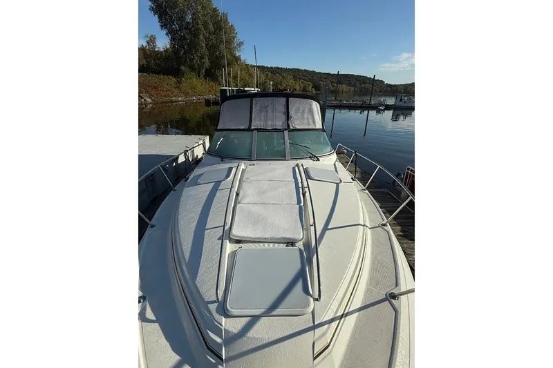Slide: The Image of 2000 Formula 31 Performance Cruiser docked at a serene marina, showcasing sleek design. - 4