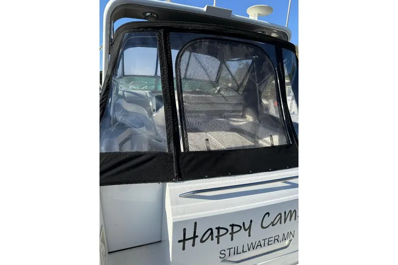 Slide: The Image of 2000 Formula 31 Performance Cruiser with black canopy, named "Happy Camper," docked in Stillwater, MN. - 5