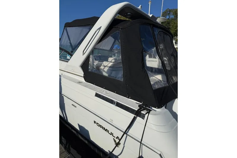 Slide: The Image of 2000 Formula 31 Performance Cruiser with black canopy, docked in marina. - 6