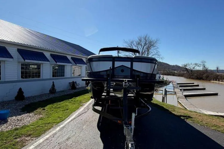 Slide: The Image of 2026 South Bay 523RS pontoon boat on trailer near waterfront dock. - 2