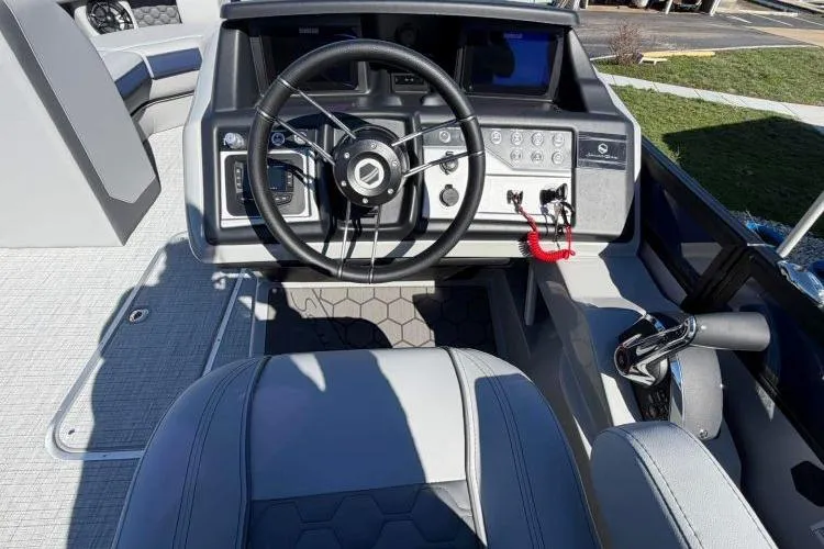Slide: The Image of 2026 South Bay 523RS boat cockpit with modern steering and control panel. - 5
