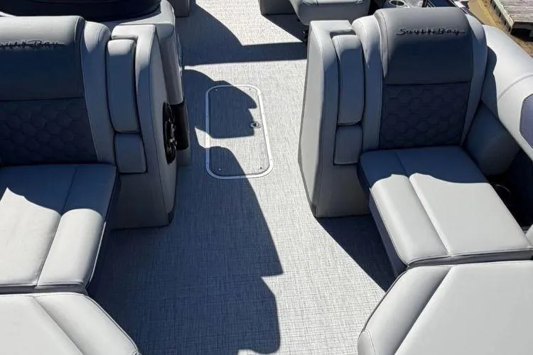 Slide: The Image of 2026 South Bay 523RS boat interior with gray seating and textured flooring. - 7