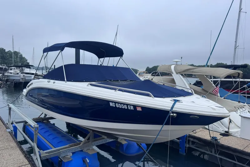 The Image of 2021 Chaparral 237 SSX boat docked at marina with blue canopy. - 0