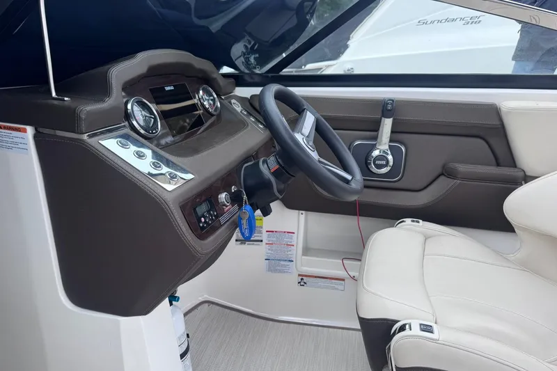 Slide: The Image of Interior view of 2021 Chaparral 237 SSX boat cockpit with steering wheel and controls. - 11