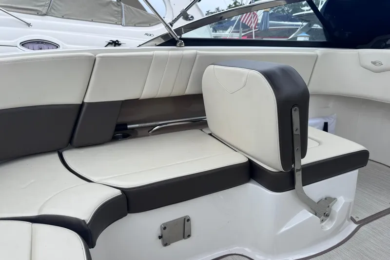 Slide: The Image of Interior seating of a 2021 Chaparral 237 SSX boat, featuring white and black upholstery. - 12