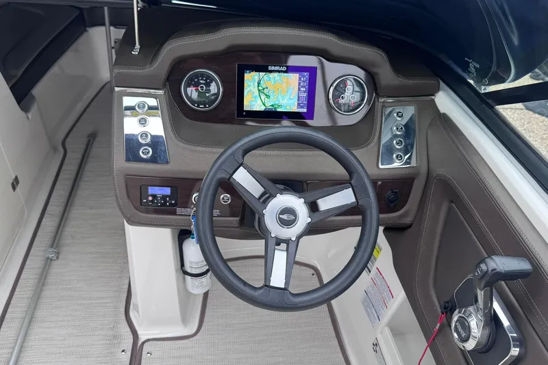 Slide: The Image of 2021 Chaparral 237 SSX boat dashboard with steering wheel and navigation display. - 13