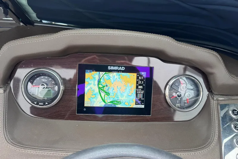 Slide: The Image of Dashboard of 2021 Chaparral 237 SSX with Simrad navigation display. - 14