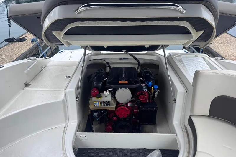 Slide: The Image of 2021 Chaparral 237 SSX boat engine compartment with open hatch, dockside view. - 20