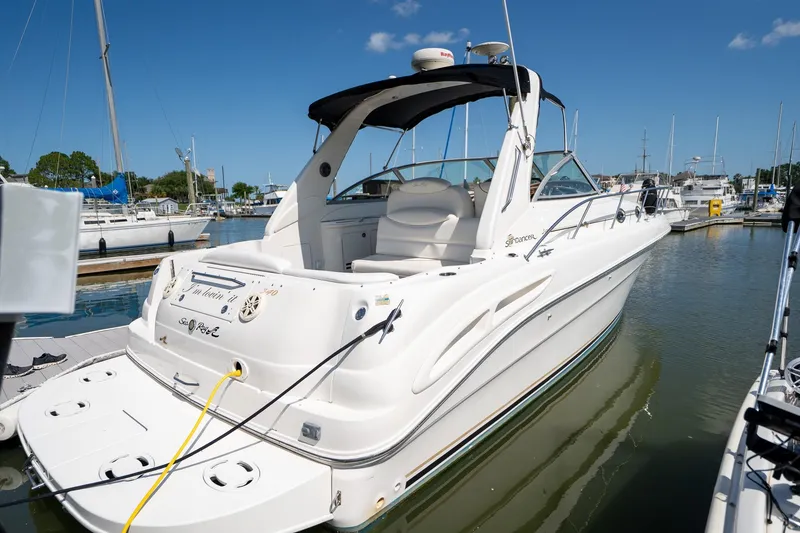 Slide: The Image of 2000 Sea Ray 340 Sundancer yacht docked in marina under clear blue sky. - 1
