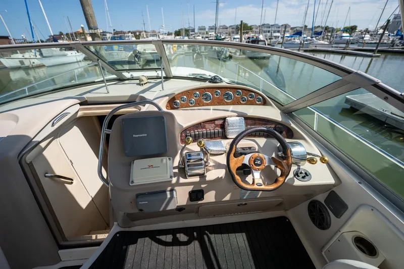 Slide: The Image of Cockpit of 2000 Sea Ray 340 Sundancer yacht with steering wheel and controls. - 10