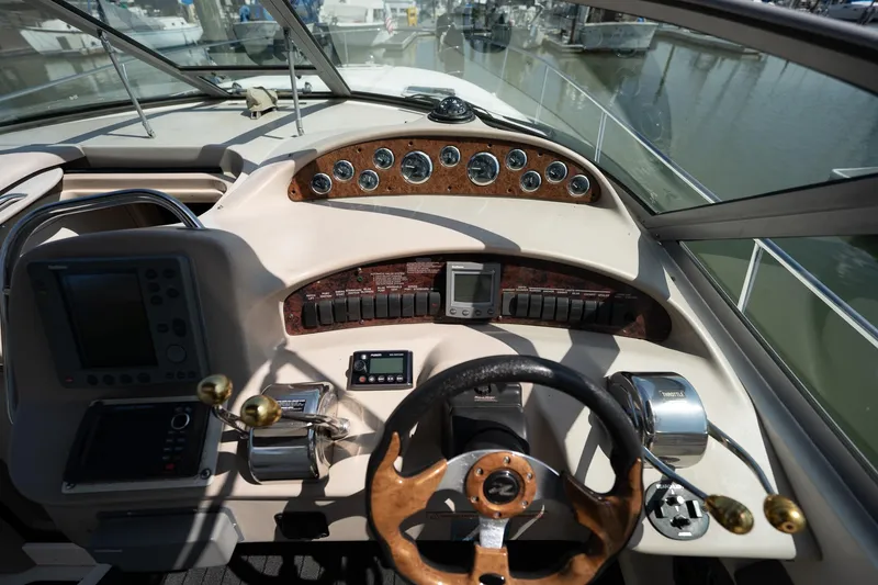 Slide: The Image of Cockpit of 2000 Sea Ray 340 Sundancer with steering wheel and control panel. - 13