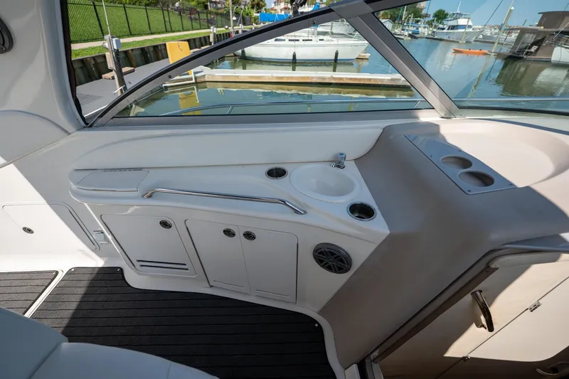 Slide: The Image of Interior view of a 2000 Sea Ray 340 Sundancer boat with sink and cup holders. - 14