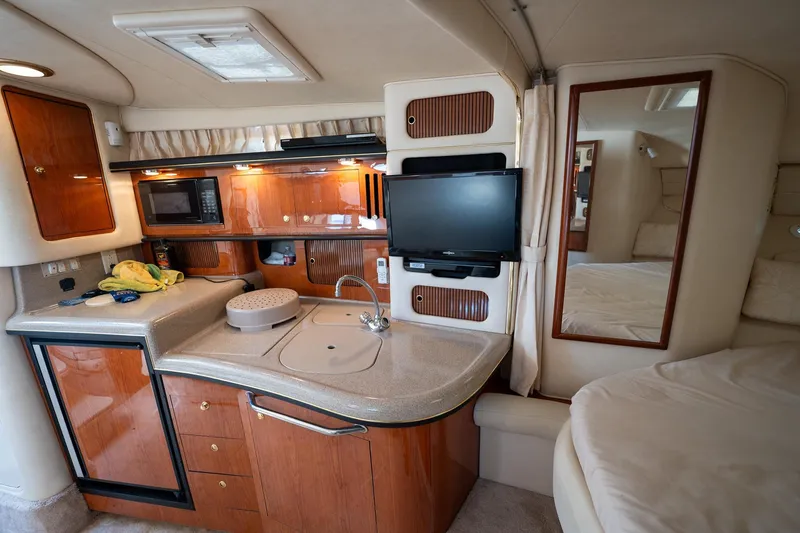 Slide: The Image of Interior of 2000 Sea Ray 340 Sundancer yacht with kitchenette and TV. - 16