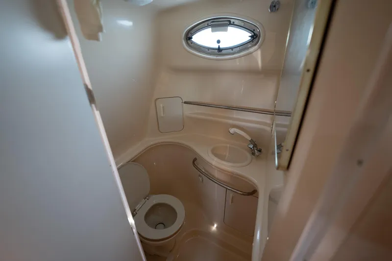 Slide: The Image of Compact bathroom in 2000 Sea Ray 340 Sundancer yacht with toilet and sink. - 17