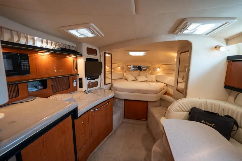 Slide: The Image of Luxurious interior of 2000 Sea Ray 340 Sundancer yacht with cozy cabin and kitchenette. - 21