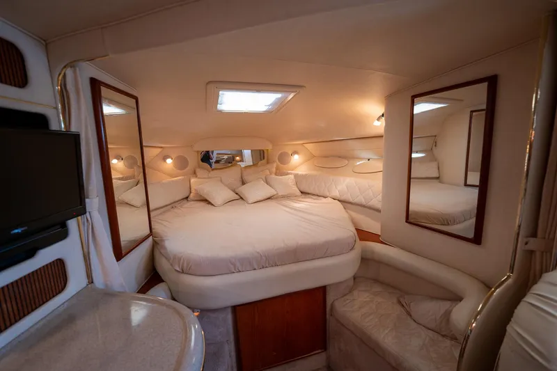 Slide: The Image of Luxurious interior cabin of 2000 Sea Ray 340 Sundancer yacht with cozy bed and mirrors. - 22