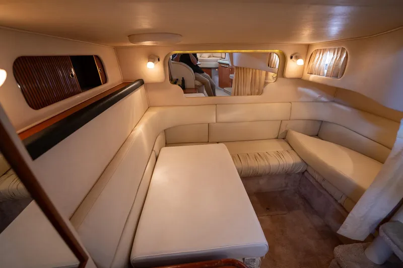 Slide: The Image of Interior of 2000 Sea Ray 340 Sundancer yacht with beige seating and ambient lighting. - 24