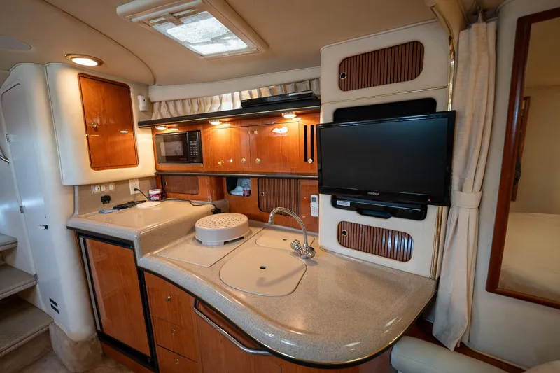 Slide: The Image of Interior of 2000 Sea Ray 340 Sundancer yacht with kitchenette and TV. - 26