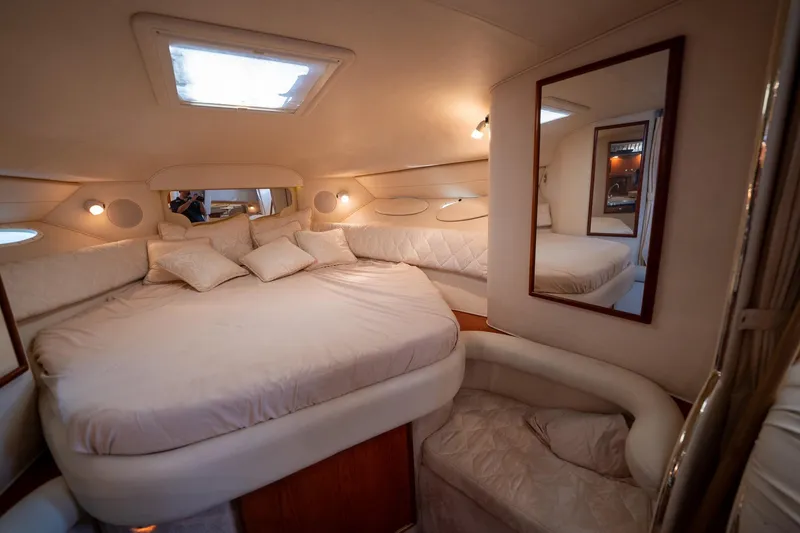 Slide: The Image of Luxurious interior of 2000 Sea Ray 340 Sundancer yacht with cozy bed and elegant decor. - 28