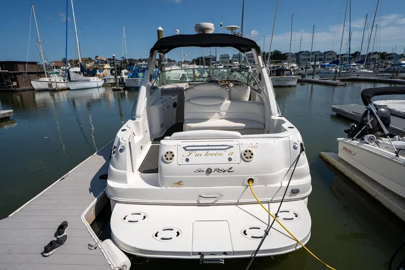 Slide: The Image of 2000 Sea Ray 340 Sundancer docked at marina, rear view. - 3