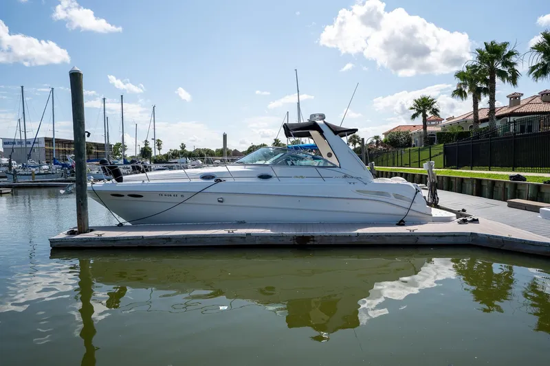 Slide: The Image of 2000 Sea Ray 340 Sundancer docked at marina under clear blue sky. - 4