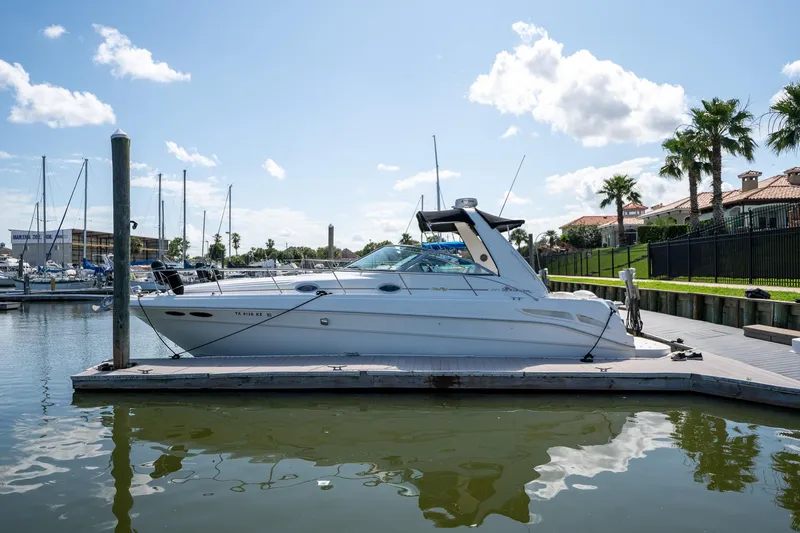Slide: The Image of 2000 Sea Ray 340 Sundancer docked at marina under clear blue sky. - 5