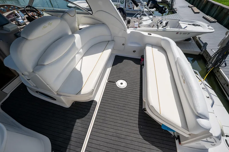 Slide: The Image of 2000 Sea Ray 340 Sundancer boat interior with white seating and modern dashboard. - 8