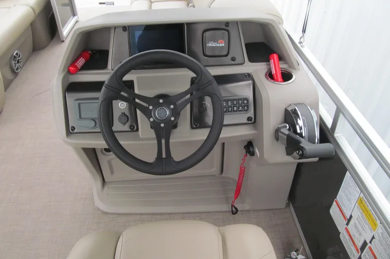 Slide: The Image of 2024 Sun Tracker Party Barge 20 DLX helm with steering wheel and control panel. - 5