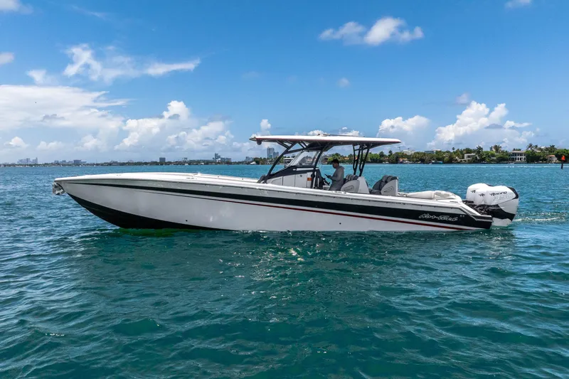 The Image of 2019 Nor-Tech 390 Sport Center Console boat cruising on clear blue water. - 0