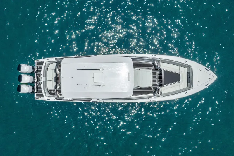 Slide: The Image of Aerial view of 2019 Nor-Tech 390 Sport Center Console on sparkling blue water. - 10